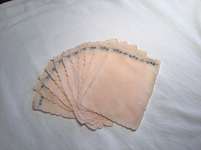 11 salmon colored vintage linen cocktail napkins with adorable embroidery at one side